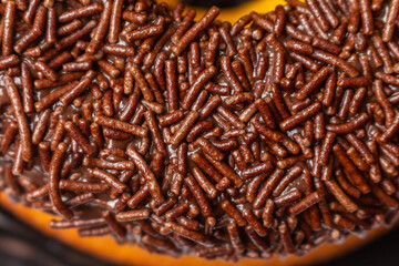 Carrot cake topped with brigadeiro and sprinkles.