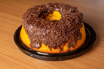 Carrot cake topped with brigadeiro and sprinkles.