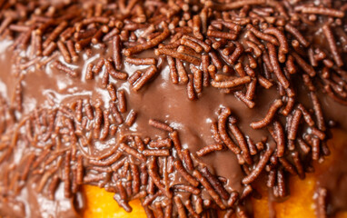 Carrot cake topped with brigadeiro and sprinkles.