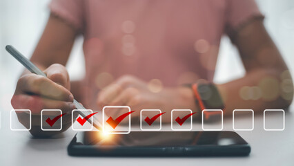 Checklist concept. Businesswoman using a laptop. Checking marks on checkboxes on the futuristic...