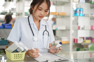 Medicine and health concept, Female pharmacist hold pill bottle and capsule to writing prescription