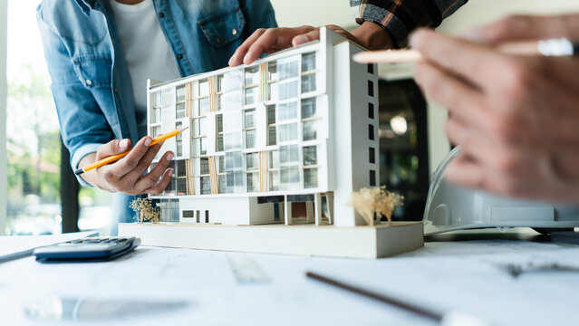 Group of engineer is discussion and brainstorming about condominium model of construction project