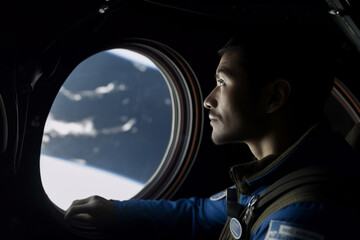 a commercial space traveler looking at the earth throughout the window at inside of the spaceship - obrazy, fototapety, plakaty