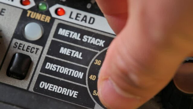 Man adjusting sound on guitar amplifier. 4k video footage UHD 3840x2160