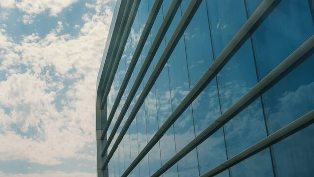 Modern glass building windows with clouds. 4k time lapse video footage