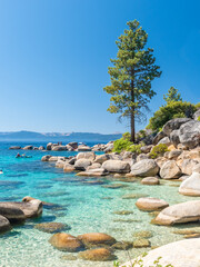 North Shore of Lake Tahoe Secret Harbor with giant granite boulders in clear blue turquoise water on a bright sunny day 
