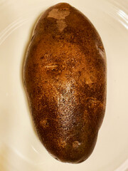 A russet baking potato on a plate