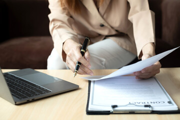 Fototapeta premium Business woman employer holding resume hiring recruit looking cv resume to hire candidates, analyzing information before job interview. Recruitment concepts