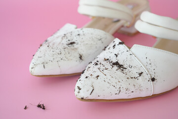 closeup of women dirty white shoe on pink background ,