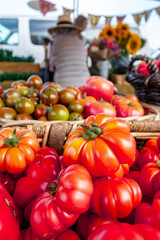 Colorful assortment of fresh organic heirloom tomatoes sitting on wooden table. High quality photo