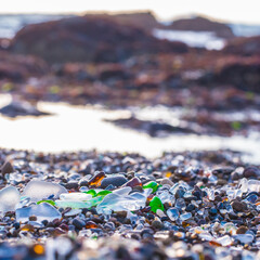 Illuminated Sea Glass on beach in Fort Bragg Mendocino County California. Former dump turned treasure as the sea polished the glass in the trash