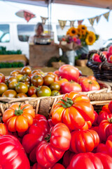 Colorful assortment of fresh organic heirloom tomatoes sitting on wooden table. High quality photo