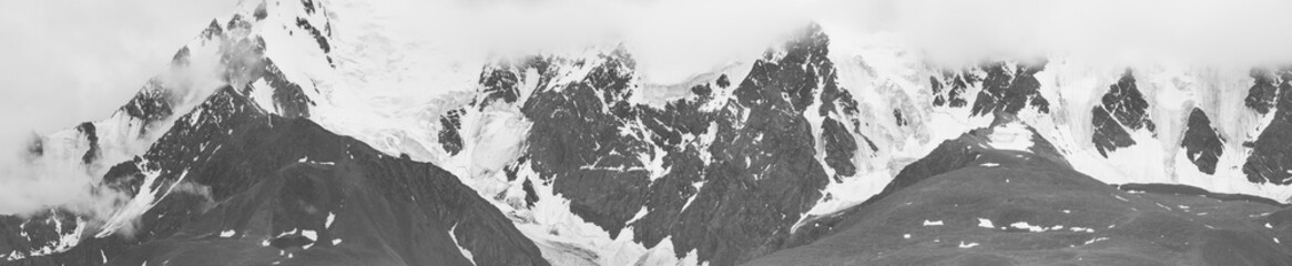 Black and white landscape, panorama. Snow-capped mountain peaks. Traveling in the mountains,...