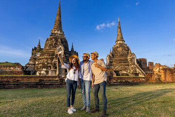 Tourists take selfie photo at Wat Phra Si Sanphet temple, Ayutthaya Thailand, for travel, vacation,...