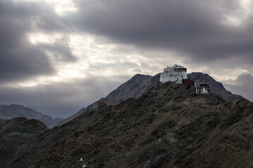 Fototapeta na wymiar Sunrise in Shey Monastery & Palace, Leh. On the top of the mountain with dramatic clouds in the back