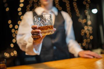 Barwoman pouring whiskey whiskey glass..