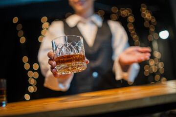 Barwoman pouring whiskey whiskey glass..