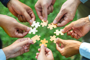 World environment day and ESG Concept of teamwork and partnership Hands join Jigsaw puzzle pieces...