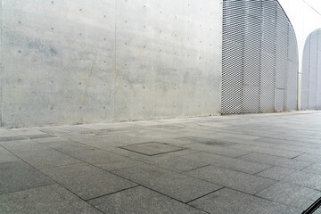 empty concrete floor in front of modern buildings in the downtown street. copy space for parking lot.