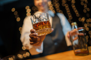 Barman pouring whiskey whiskey glass beautiful night