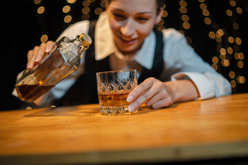 Barman pouring whiskey whiskey glass beautiful night
