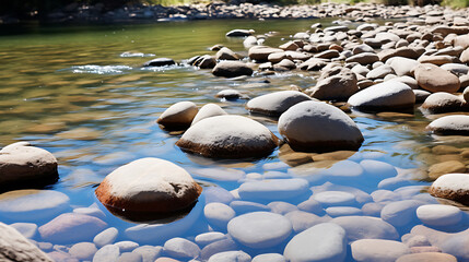 Present a picture of stones on a riverbed, partially submerged in water.