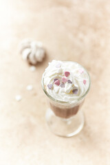 Coffee with whipped cream on bright stone background. Soft focus. Close up.	