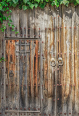 antique wooden door with metal rivets illuminated by sunlight