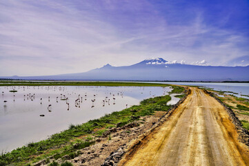 Picture perfect scene of the entire Kilimanjaro range with bright blue skies over serene Lake...