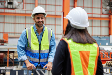 engineer or worker talking and meeting with coworker in the metal sheet factory