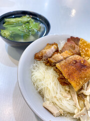 A Bowl of Delicious rice noodles Pangsit (bihun Pangsit) . Various pork meat rice noodles with dumpling and fried dumpA Bowl of Delicious rice noodles Pangsit (bihun Pangsit) . Various pork meat rice 