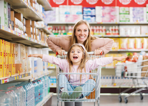 Mother and daughter playing together at the grocery store