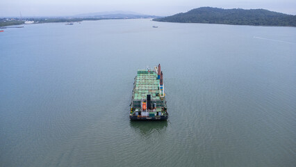 Aerial view of a large ship carrying containers in the Kalimantan sea, shipping containers, inter...