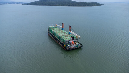 Aerial view of a large ship carrying containers in the Kalimantan sea, shipping containers, inter island trade