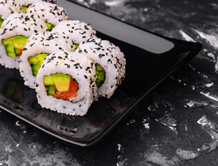 Delicious avocado sushi roll with salmon