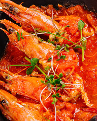 freshly cooked prawns in spicy tomato sauce and fish in batter