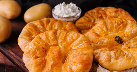 Cooking traditional pies with potato on wooden board