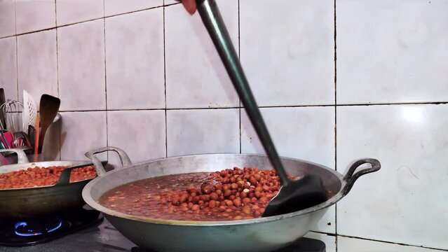 frying large amounts of peanuts in the process of making pecel seasoning