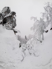 Hiking trail is covered with snow. Narrow passage