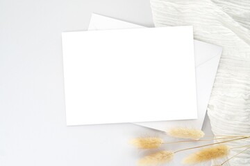 Blank horizontal card mockup for art, design presentation, white envelope, flat lay composition, wedding concept.