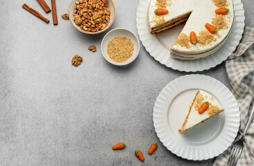 Homemade carrot cake made with walnuts, iced with cream cheese. Sweet dessert.