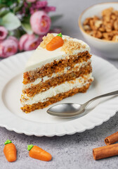 Homemade carrot cake made with walnuts, iced with cream cheese. Sweet dessert.