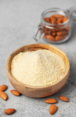 Fresh almond flour in a  bowl and almonds