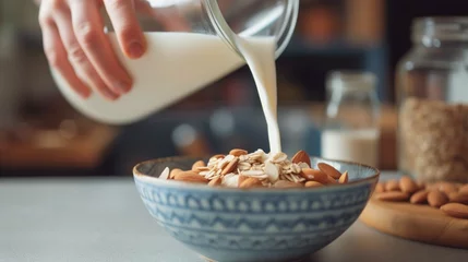 Fotobehang Healthy start to the day: pouring almond milk over a bowl of granola, nuts, and seeds, a nutritious breakfast choice for a wellness lifestyle.  © CuratedAIMasterpiece