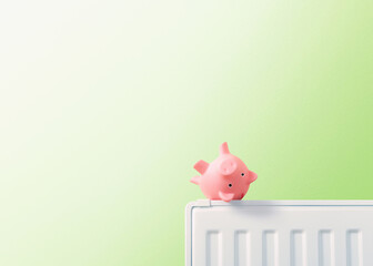 empty piggy bank turned upside down on the edge of a radiator, heating costs and energy prices,...