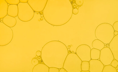 Oil and water bubbles of an art image on golden yellow gradient background. Ideal as app design background, template, all season sale poster etc.,.