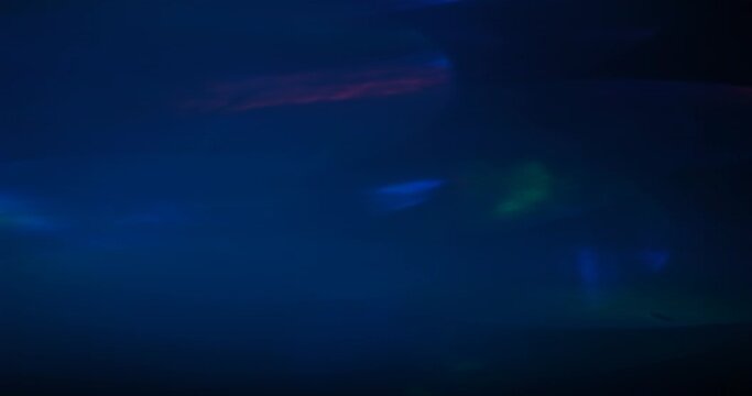 Multicolored light leaks 4k footage on black background. Lens studio flare leak burst overlays.