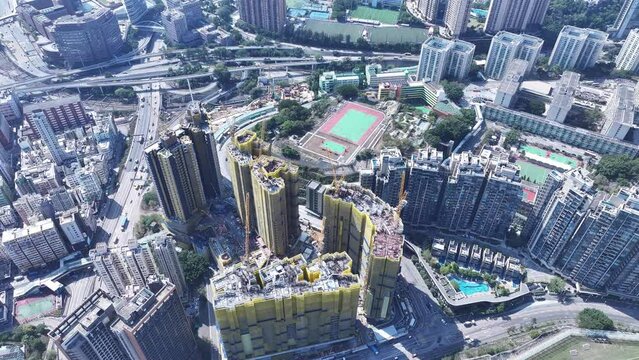 A railway and subway station railroad cover residential project built on a hillside slope in Ho Man Tin, aerial View of the skyline of Hong Kong at Victoria Harbour Financial Kowloon Peninsula 