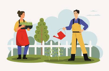 Agricultural employees working in garden with tools
