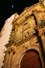 Cathedral facade with white towers in the Unesco city of Caceres at night, Spain.